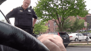 This is a still from Adam's camera, taken just before the officer in the photo pepper sprayed Adam, as he sat unarmed, harmless, and restrained in his car. 